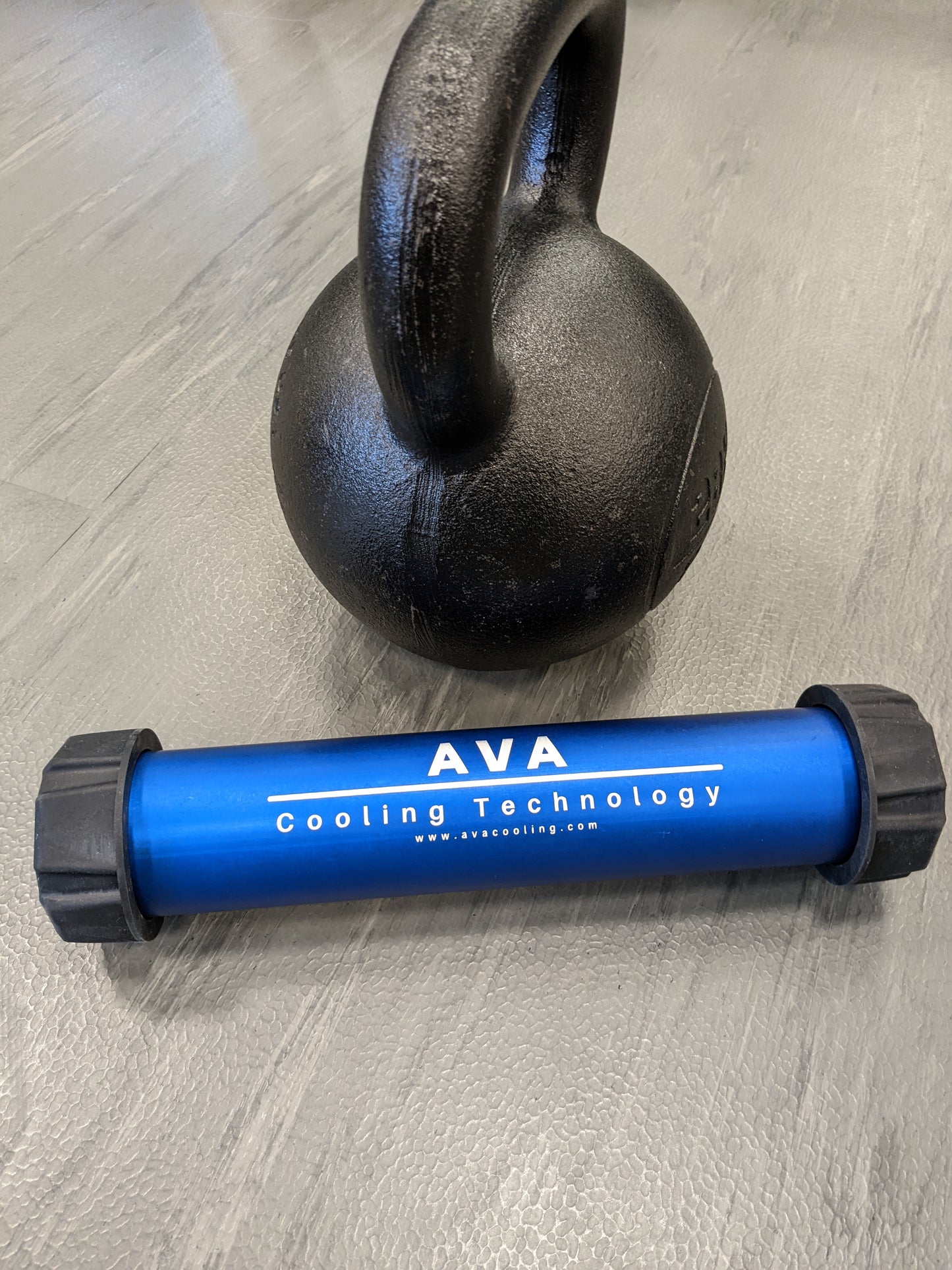 Blue AF Charge Bar next to kettlebell